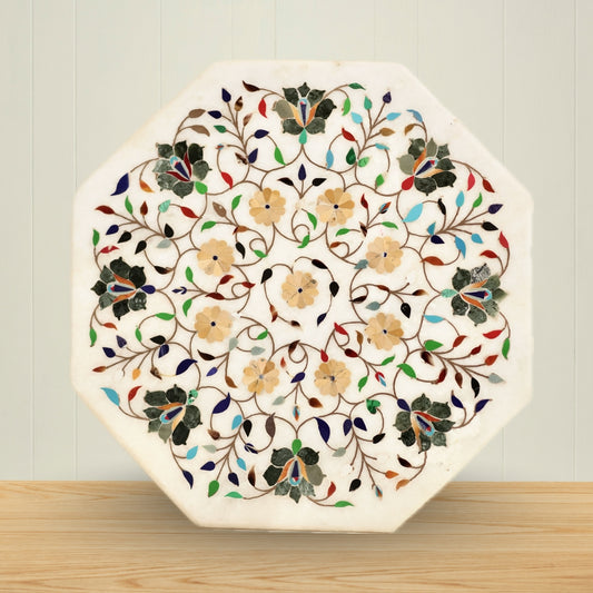 White marble table top featuring detailed gemstone inlay