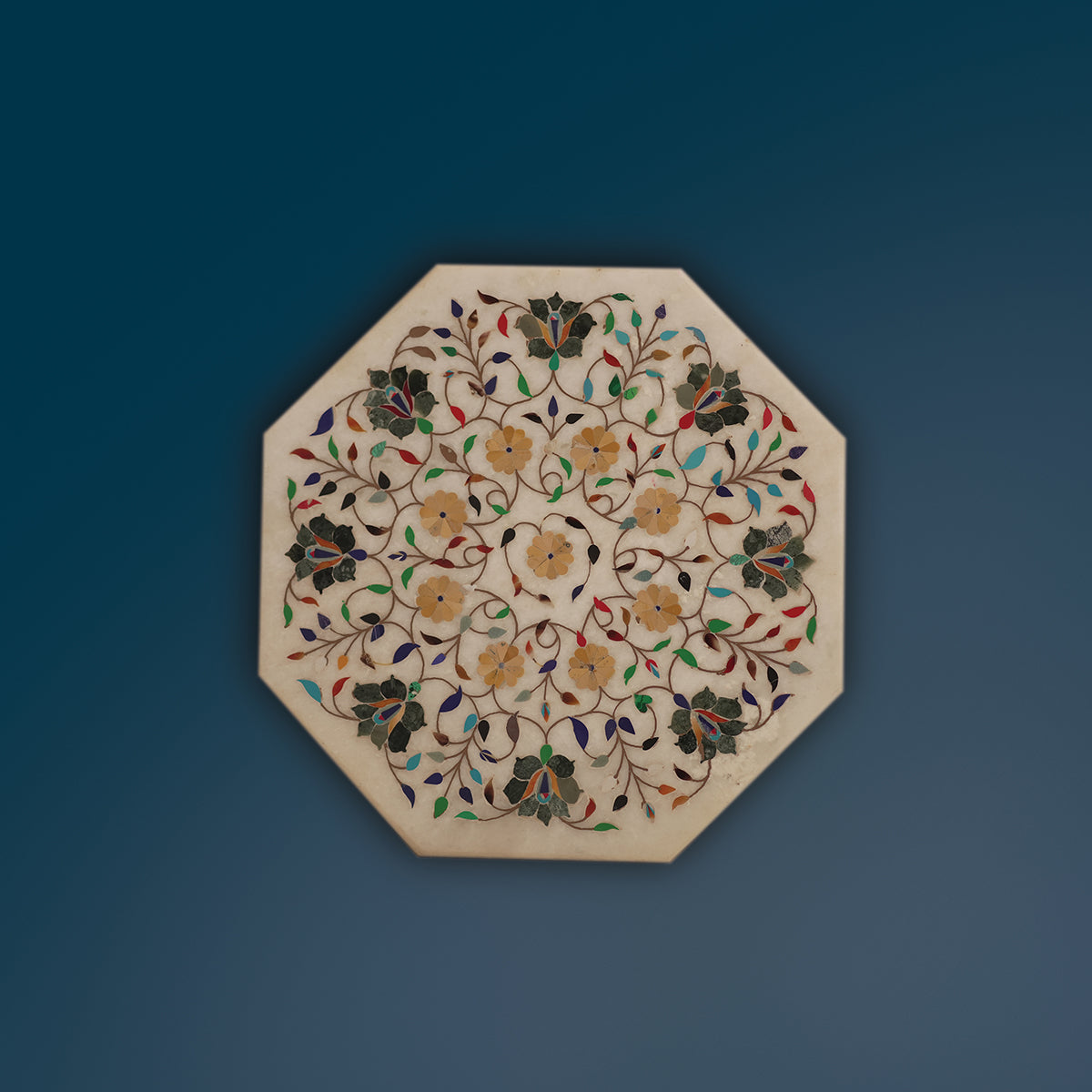White marble table top featuring detailed gemstone inlay